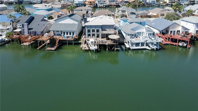 drone / aerial view with a residential view and a water view