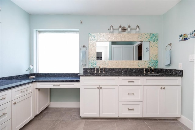 full bathroom featuring double vanity, tile patterned floors, and a sink