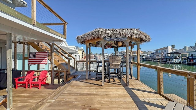 dock area featuring stairway and a water view