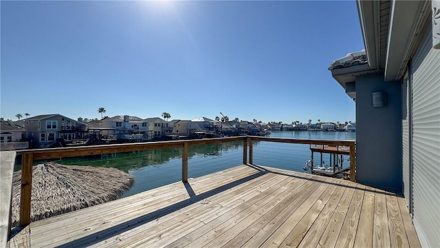 dock area featuring a water view and a residential view