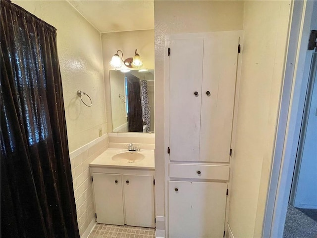 bathroom with tile walls and vanity