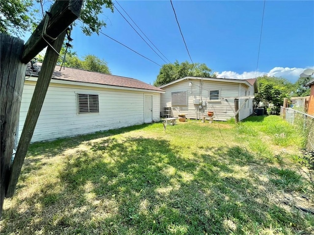 back of property featuring a lawn