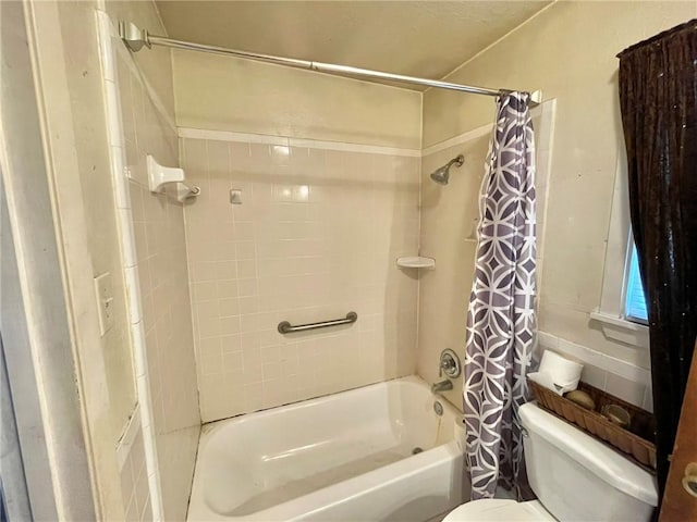 bathroom featuring toilet and shower / bath combo