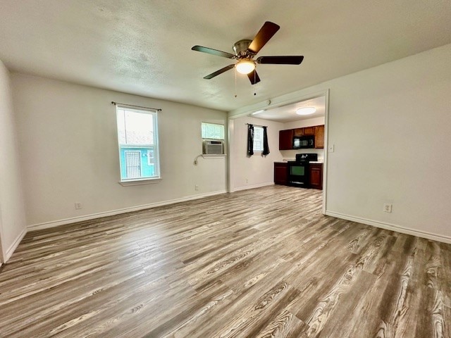 unfurnished living room with ceiling fan, wood-type flooring, and a textured ceiling