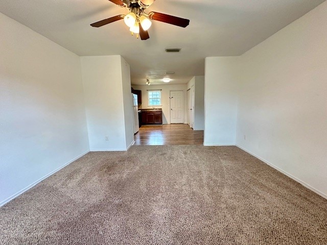 unfurnished room featuring carpet flooring and ceiling fan