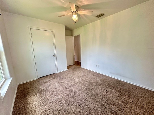 unfurnished bedroom featuring a closet, carpet, and ceiling fan