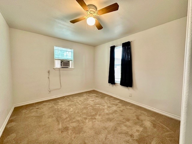 carpeted empty room featuring cooling unit and ceiling fan