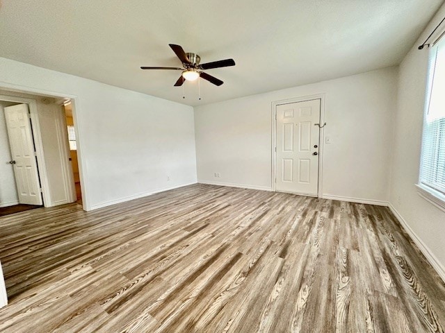 empty room featuring ceiling fan and light hardwood / wood-style floors