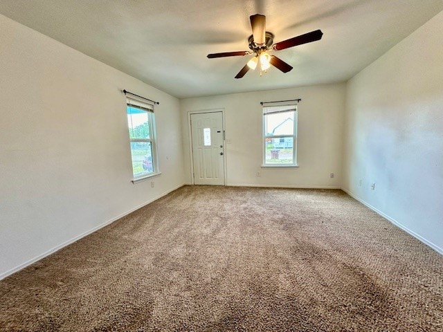 empty room with ceiling fan and carpet flooring