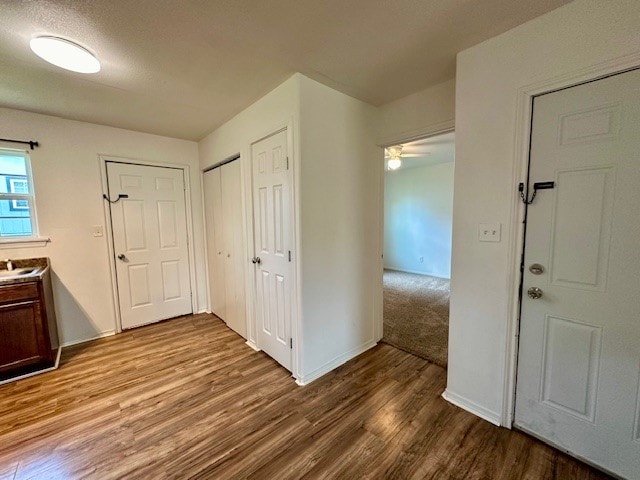 hall featuring a textured ceiling and hardwood / wood-style flooring