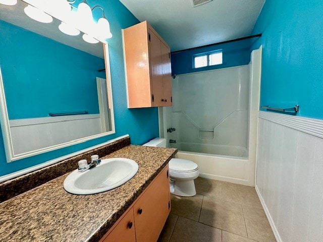 full bathroom featuring vanity, tile patterned flooring, toilet, and shower / bath combination