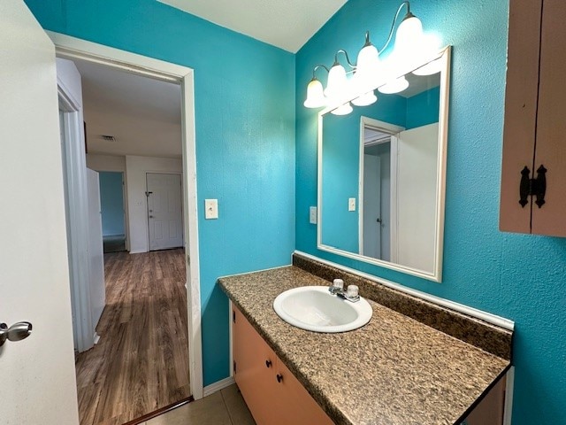 bathroom featuring wood-type flooring and vanity