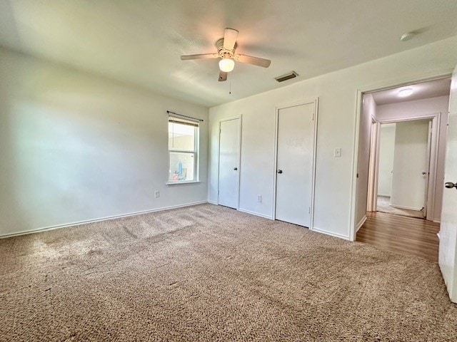 unfurnished bedroom featuring ceiling fan and carpet flooring