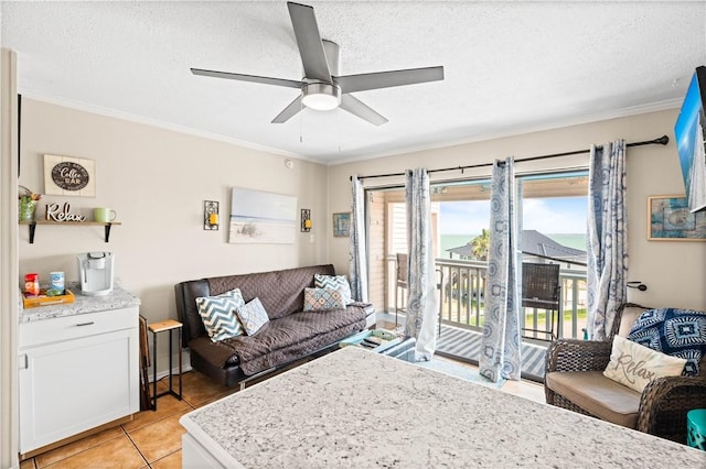 3938 Surfside Blvd Unit 1316, Corpus Christi, TX 78402 - living room with ceiling fan, crown molding, a textured ceiling, and light tile patterned flooring