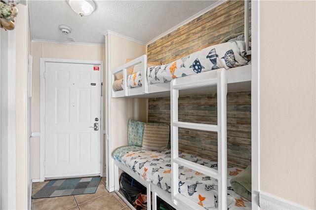 3938 Surfside Blvd Unit 1316, Corpus Christi, TX 78402 - mudroom featuring crown molding, tile patterned flooring, and a textured ceiling