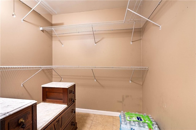 spacious closet featuring light tile patterned flooring