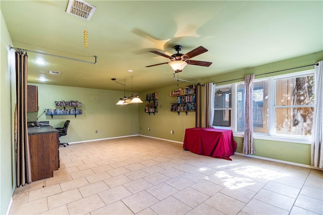 interior space with light tile patterned floors and ceiling fan