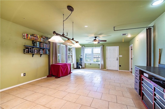 interior space featuring light tile patterned floors and ceiling fan