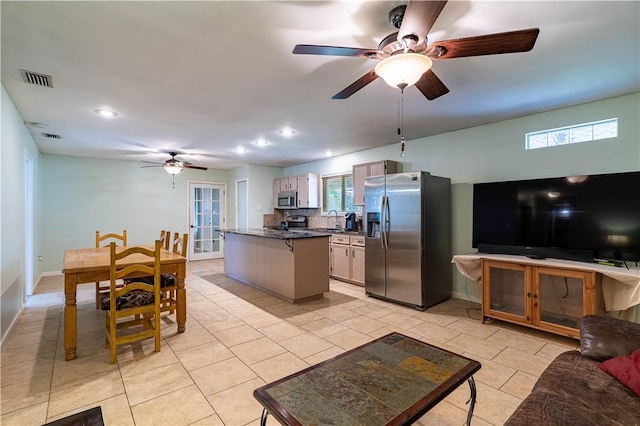 177 Grapevine Dr, Rockport, TX 78382 - kitchen featuring appliances with stainless steel finishes, a sink, a ceiling fan, dark countertops, and recessed lighting