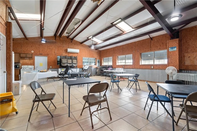 dining space with light tile patterned flooring, vaulted ceiling with beams, a wall mounted AC, and wooden walls