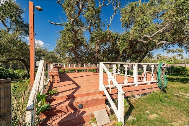 wooden terrace featuring a yard