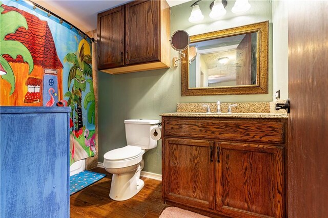 full bathroom featuring wood-type flooring, toilet, shower / tub combo, and vanity