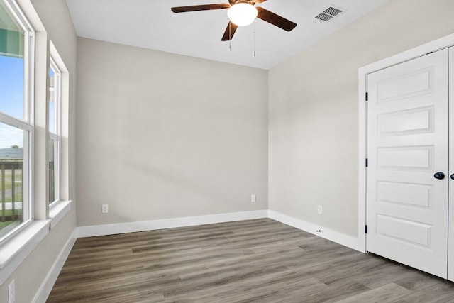 spare room with hardwood / wood-style flooring and ceiling fan