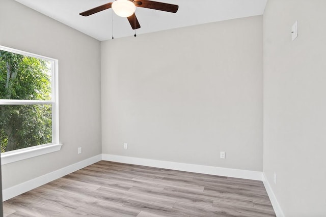 spare room featuring ceiling fan, a healthy amount of sunlight, and light hardwood / wood-style floors