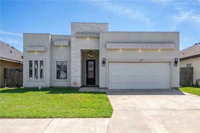view of front of property featuring a front lawn, fence, stucco siding, a garage, and driveway