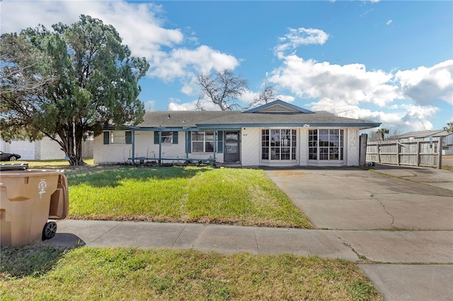 single story home with fence and a front yard