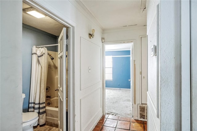 corridor with carpet, visible vents, and crown molding