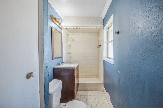 full bathroom with a textured wall, toilet, vanity, a stall shower, and crown molding