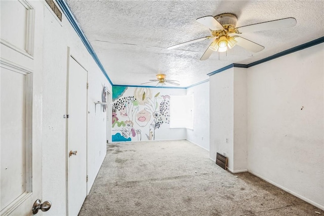 spare room with crown molding, a textured ceiling, ceiling fan, and carpet flooring