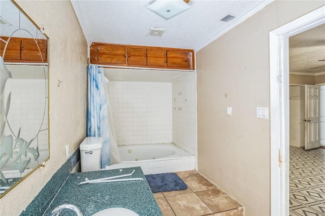 bathroom with ornamental molding, a tub with jets, a textured ceiling, and visible vents