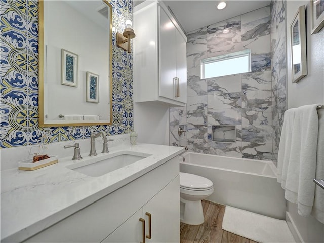 full bathroom featuring toilet, shower / bathing tub combination, wood finished floors, and vanity