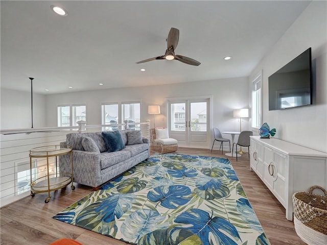 living room with plenty of natural light, wood finished floors, and recessed lighting