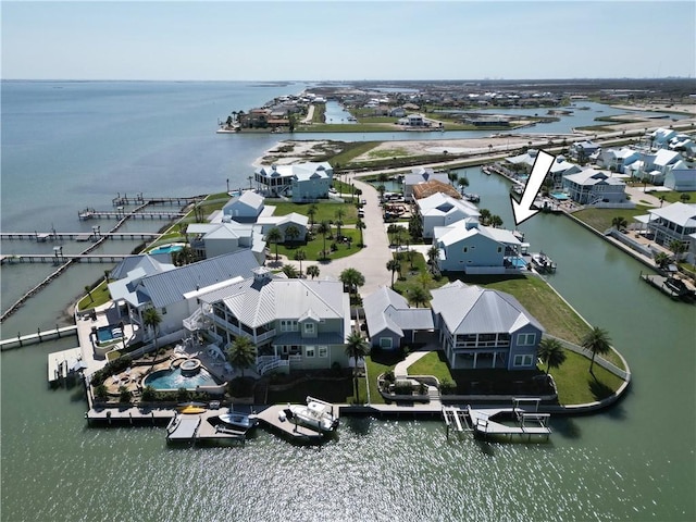 drone / aerial view with a water view and a residential view