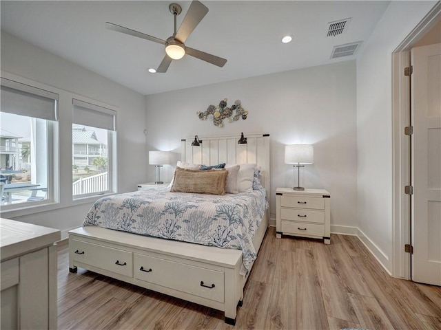 bedroom featuring light wood-type flooring, visible vents, and baseboards