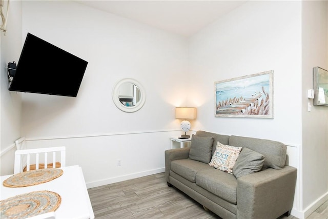 living area featuring wood finished floors and baseboards