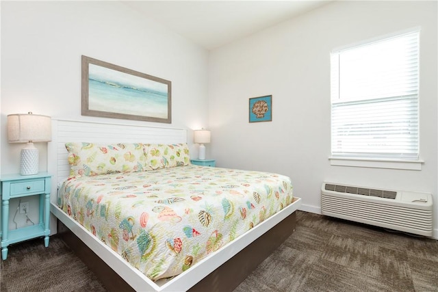 bedroom featuring dark carpet, baseboards, and a wall mounted AC