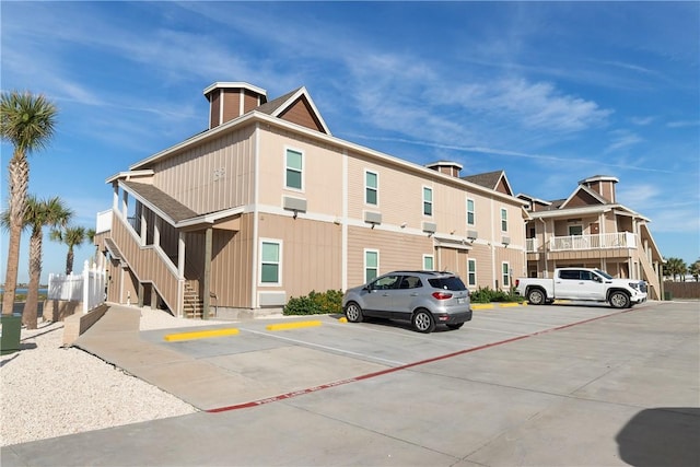 view of property with uncovered parking