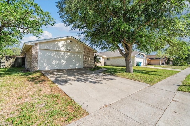 4121 Woodland Creek Dr, Corpus Christi, TX 78410 - ranch-style house with concrete driveway, a front yard, a garage, and brick siding