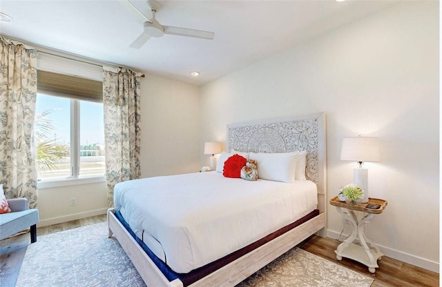 bedroom featuring hardwood / wood-style floors and ceiling fan