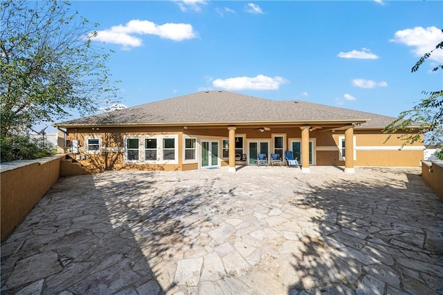 rear view of house featuring ceiling fan and a patio