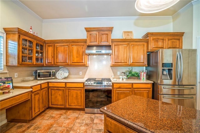 kitchen featuring stainless steel appliances, crown molding, and decorative backsplash