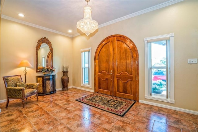 foyer entrance featuring a chandelier and ornamental molding