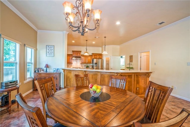 dining area featuring crown molding and a chandelier