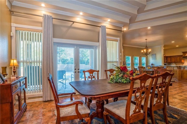 dining area featuring a chandelier, ornamental molding, and french doors