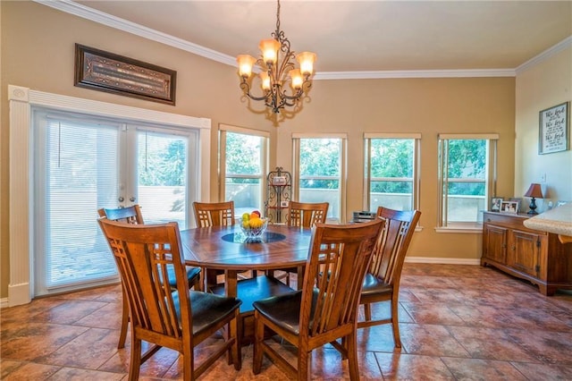 dining space featuring crown molding and a notable chandelier