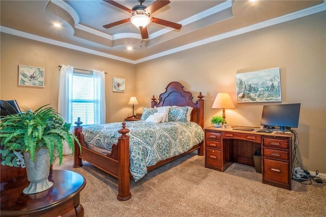 carpeted bedroom with ceiling fan, ornamental molding, and a tray ceiling